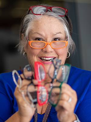Susan O'Bryan displays several of her 42 pairs of reading glasses.